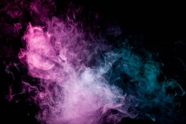 Textural background for creativity. Colorful pink and blue smoke  on a black isolated background. Background from the smoke of vap