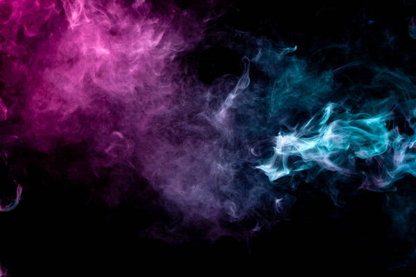 Textural background for creativity. Colorful pink and blue smoke on a black isolated background. Background from the smoke of vap