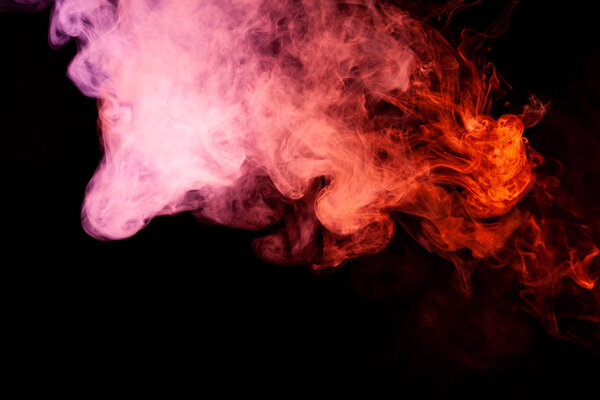 Textural background for creativity. Colorful pink and red smoke on a black isolated background. Background from the smoke of vap