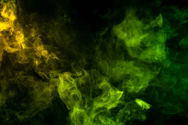 Textural background for creativity. Green and yellow  cloud smoke on black  isolated backgroun