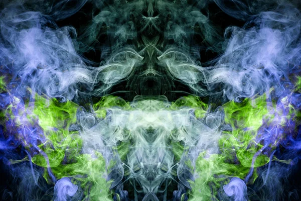 Fantasy print for clothes: t-shirts, sweatshirts.  Colorful blue and green smoke in the form of a skull, monster, dragon on a black isolated background. Background from the smoke of vap