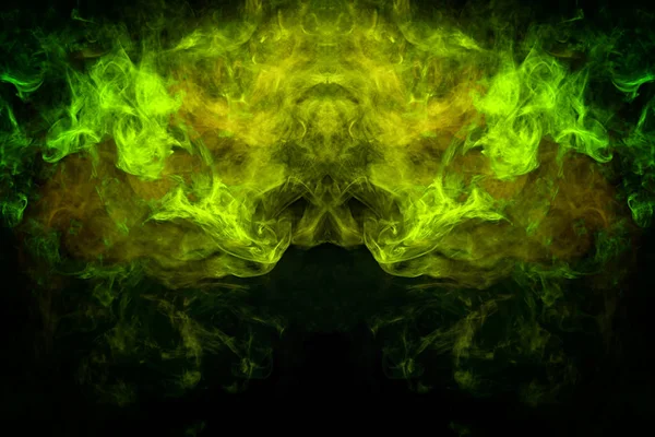 Mocap for cool t-shirts. Cloud of yellow and green smoke in the form of a skull, monster, dragon on a black isolated background. Background from the smoke of vape