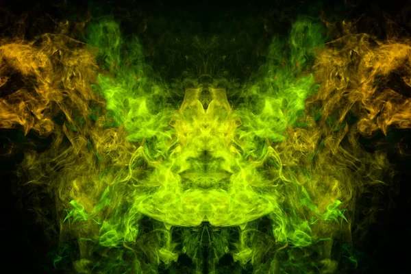 Mocap for cool t-shirts. Cloud of yellow and green smoke in the form of a skull, monster, dragon on a black isolated background. Background from the smoke of vape