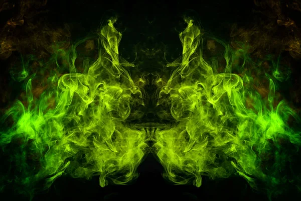 Mocap for cool t-shirts. Cloud of yellow and green smoke in the form of a skull, monster, dragon on a black isolated background. Background from the smoke of vape