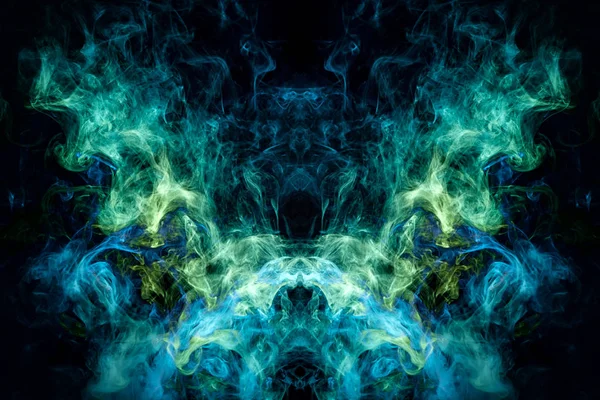 Fantasy print for clothes: t-shirts, sweatshirts. Thick colorful smoke of green, blue colors smoke in the form of a skull, monster, dragon on a black isolated background. Background from the smoke of vap