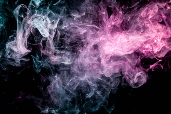Dense multicolored smoke of blue and pink colors on a black isolated background. Background of smoke vape