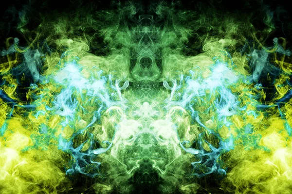 Mocap for cool t-shirts. Thick colorful blue, yellow and green smoke  in the form of a monster on a black isolated background. Background from the smoke of vape