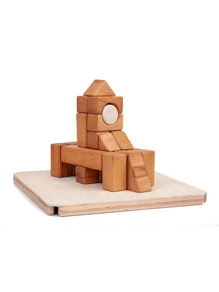 Photo wooden constructor of small cubes, triangles, balls and other forms of beech on a white isolated background. Wooden designer, built in the shape of the castle