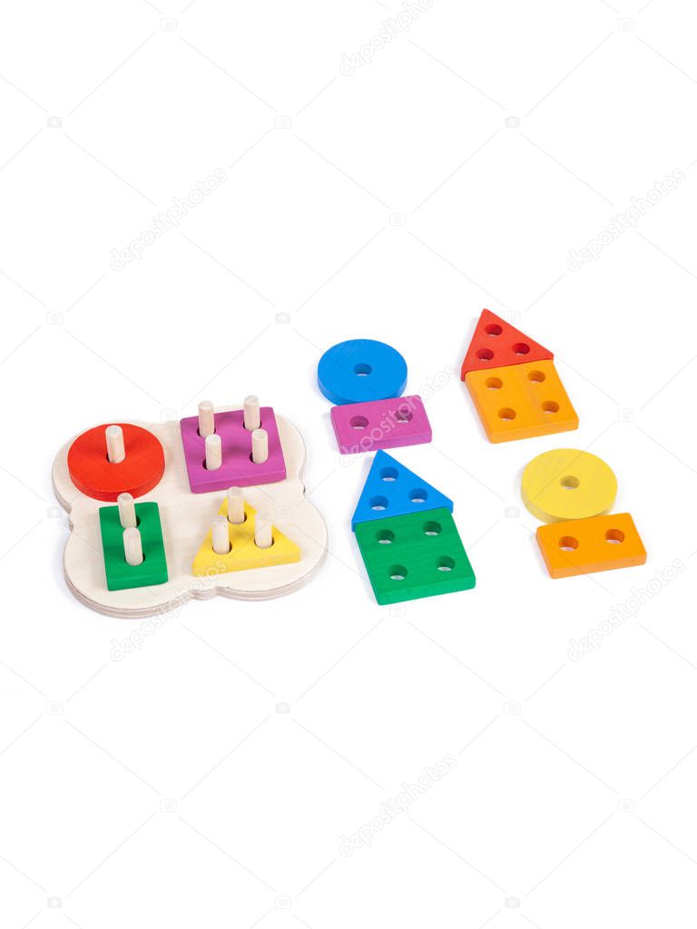 Photo of a wooden toy  children's sorter with small wooden details in the form of geometric shapes (rectangle, square, circle, triangle), in different colors  on a white isolated background