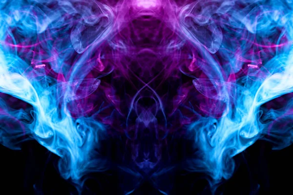 Fantasy print for clothes: t-shirts, sweatshirts.  Colorful pink and blue smoke in the form of a skull, monster, dragon on a black isolated background. Background from the smoke of vap