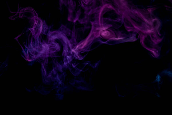 Colorful pink and blue smoke on a black isolated background. Background from the smoke of vap