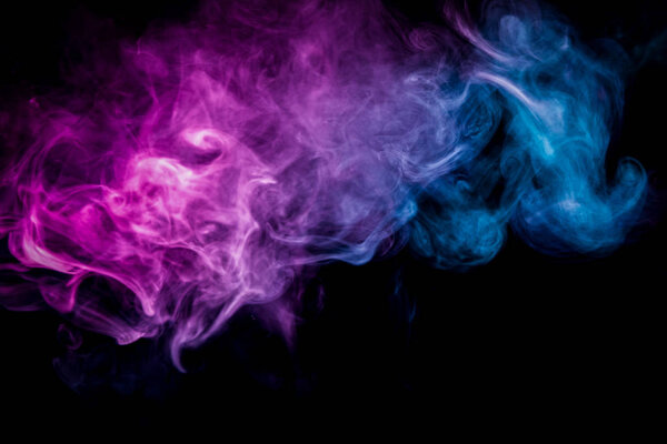 Cloud of pink and blue smoke on a black isolated background. Background from the smoke of vap