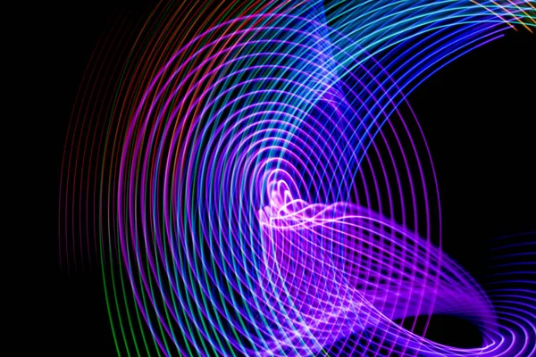 Abstract light blue, purple, red, green and yellow trails in random motion background image. Striped Neon Lights in Rainbow Colors