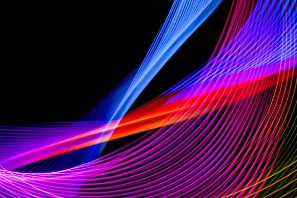 Abstract light rainbow trails in random motion background image.  Striped Neon Lights in Rainbow Colors