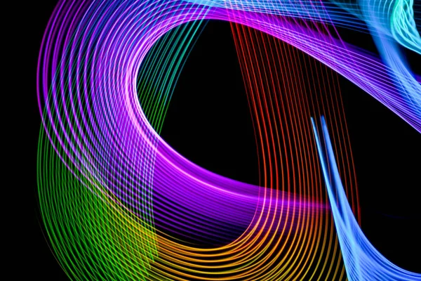 Abstract light rainbow trails in random motion background image.  Striped Neon Lights in Rainbow Colors