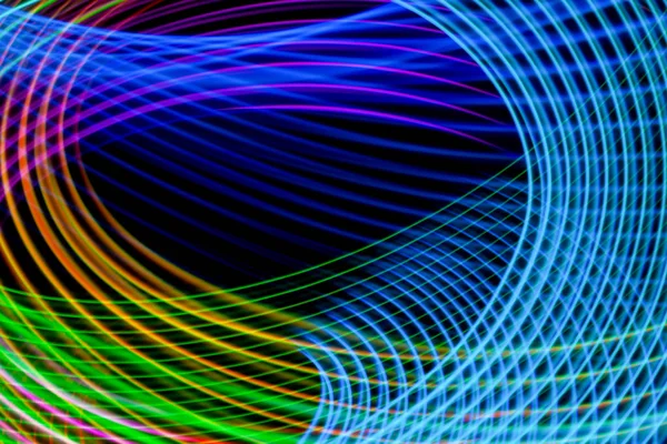 Abstract light rainbow trails in random motion background image.  Striped Neon Lights in Rainbow Colors