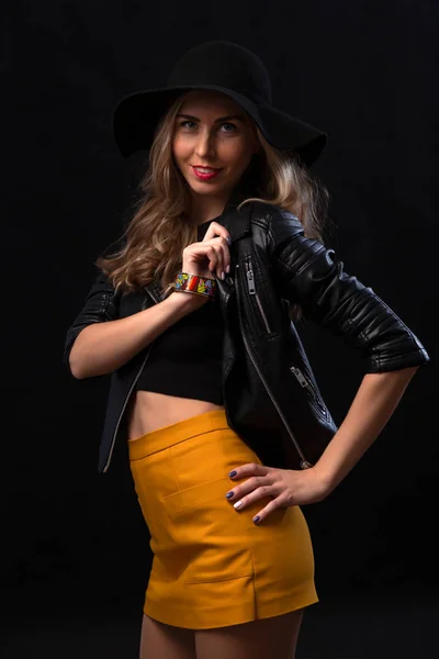 Blissful attractive woman with flowing hair laughs during a photo shoot. Graceful sweet girl in romantic casual clothes enjoying free time in the studio