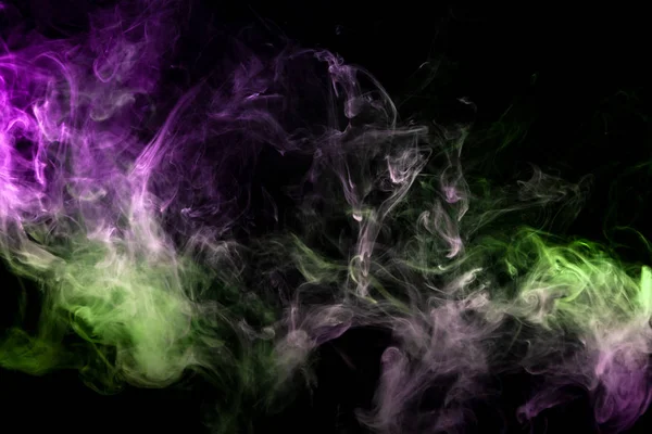 Purple  and green cloud of smoke of  black isolated background. Background from the smoke of vap