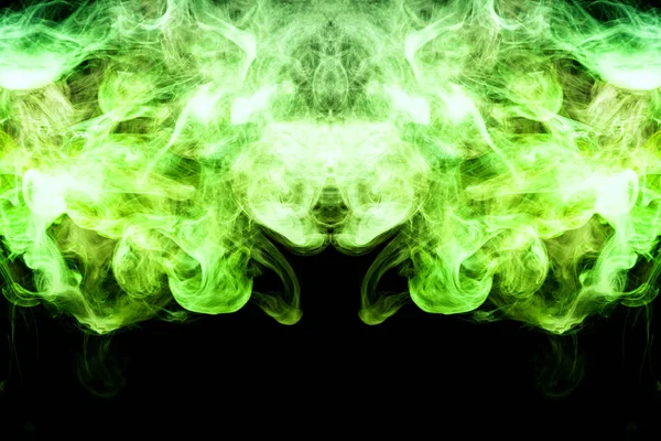 Fantasy print for clothes: t-shirts, sweatshirts.  Colorful green smoke in the form of a skull, monster, dragon on a black isolated background. Background from the smoke of vap