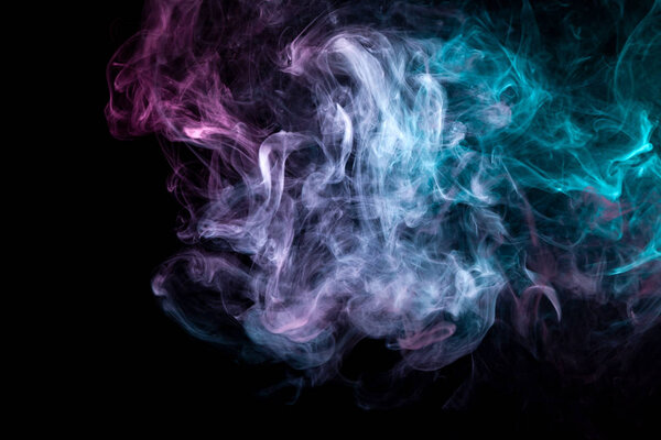 Dense multicolored smoke of blue and punk colors on a black isolated background. Background of smoke vape