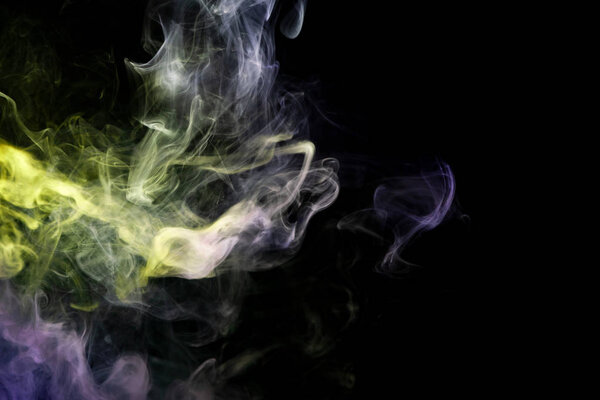 Thick blue and green smoke on a black isolated background. Background from the smoke of vap