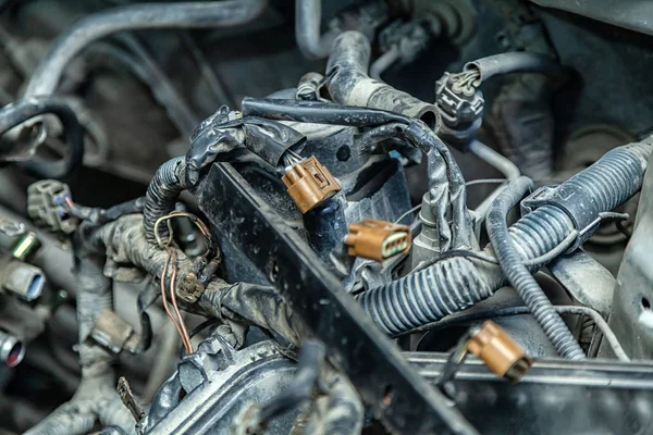 Close-up of the wiring of the engine of a supported car