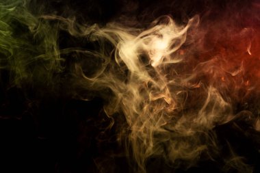 Duman siyah bir izole arka plan üzerinde renkli sarı ve turuncu. Vap duman arka plan