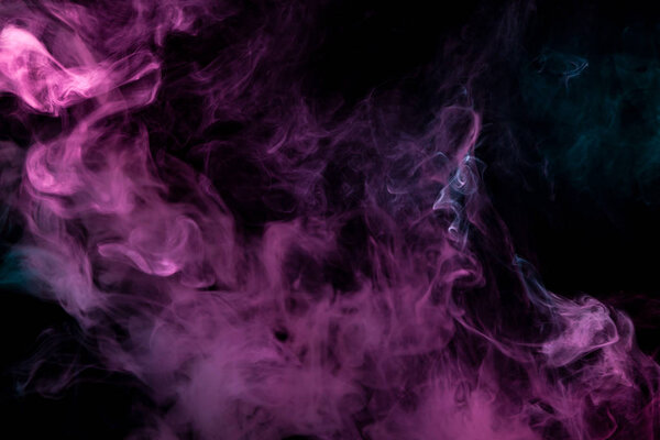 Cloud of pink and blue smoke on a black isolated background. Background from the smoke of vap