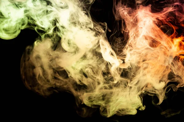 Colorful yellow and orange smoke  on a black isolated background. Background from the smoke of vap