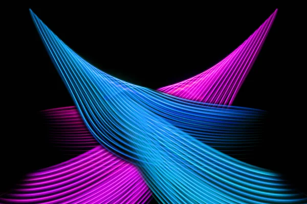 Abstract light blue, pink and yellow trails in random motion background image.Striped Neon Lights in Rainbow Colors