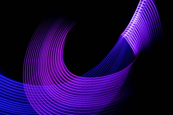 Abstract light blue, pink and yellow trails in random motion background image.Striped Neon Lights in Rainbow Colors