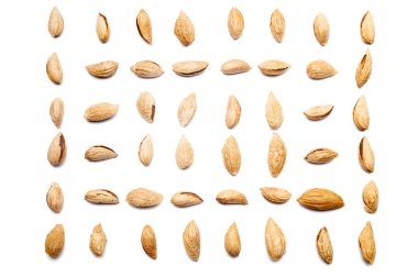 A collection of peeled almonds Badam lie in horizontal rows on an isolated white background. with clipping path. Peeled almonds Badam pattern