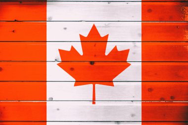 National flag of Canada  on a  wooden background