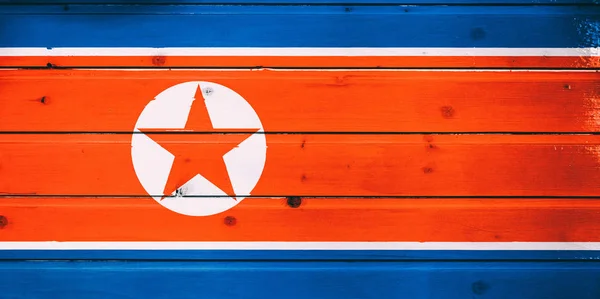 National flag of North Korea  on a  wooden background