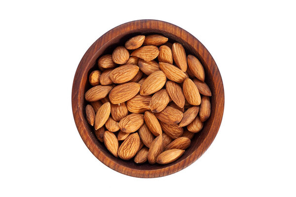 Peeled  almond  in a wooden cedar plate on a white isolated background. Row of bowls with almond  nuts, top view. Peeled  almond pattern