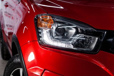 Novosibirsk, Russia - February 01, 2019:  Ssangyong Actyon,  close-up of the headlights. Photography of a modern car on a parking in Novosibirs clipart