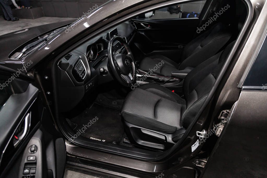 Novosibirsk, Russia - February 05, 2019:  Mazda 3, close-up of the dashboard, speedometer and tachometer, seats and steering wheel. Photography of a modern car on a parking in Novosibirs