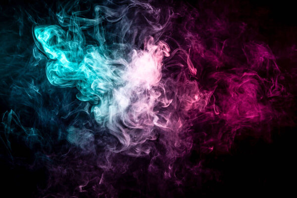 Close up swirling pink and blue smoke on black isolated background