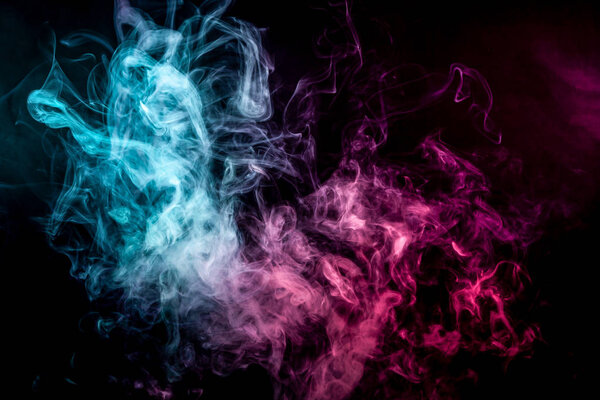 Cloud of pink and blue smoke on a black isolated background. Background from the smoke of vap