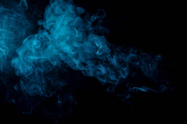 Blue bomb smoke on black isolated background