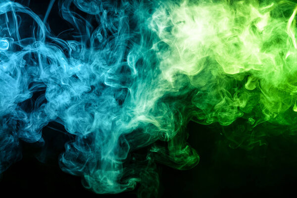 Blue and green bomb smoke on black isolated background