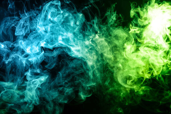 Blue and green bomb smoke on black isolated background
