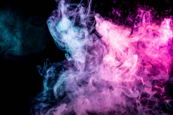 Thick pink and blue smoke on a black isolated background. Background from the smoke of vap