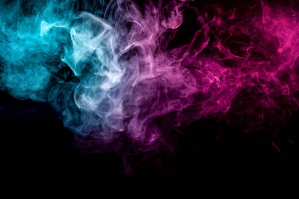 Frozen abstract movement of explosion smoke multiple blue and pink colors on black background. Background from the smoke of vap