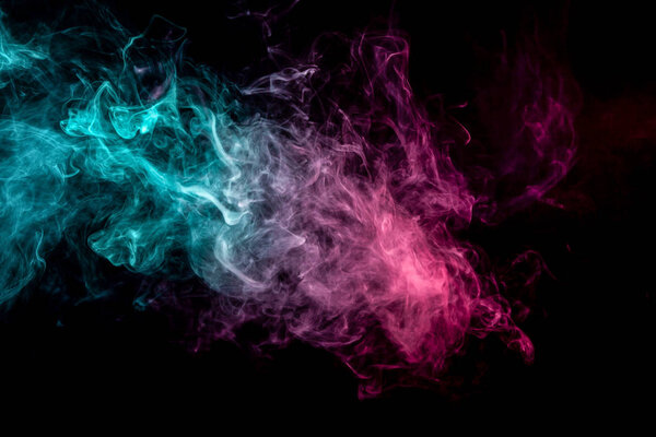 Frozen abstract movement of explosion smoke multiple blue and pink colors on black background. Background from the smoke of vap