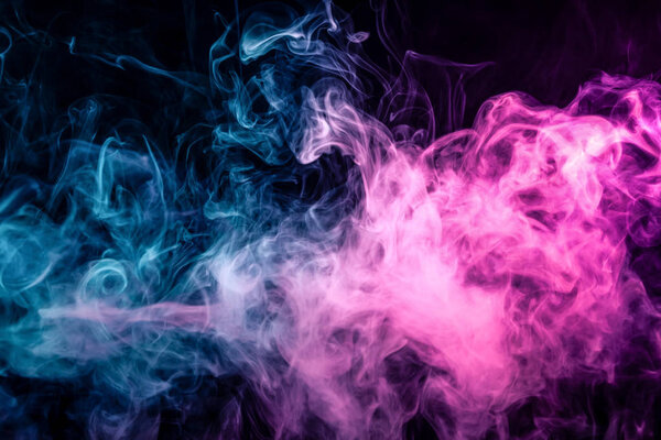 Fog colored with bright pink and blue smoke on dark backgroun