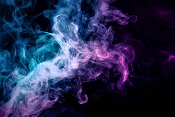 Dense multicolored smoke of blue and purple colors on a black isolated background. Background of smoke vap