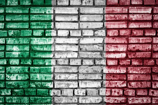 National flag of Italy on a brick background. Concept image for Italy: language , people and culture.