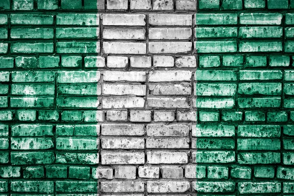 National flag of  Nigeria on a brick background. Concept image for Nigeria: language , people and culture.