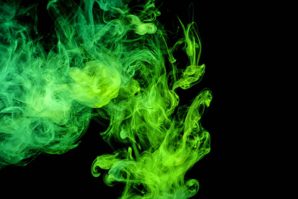 Dense green smoke on a black isolated background. Background of smoke vap
